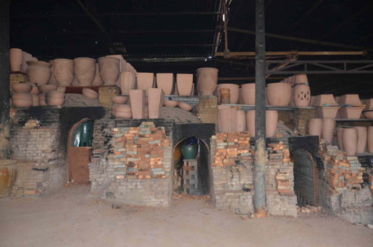 image of a wood-fired kiln with pottery inside and on top