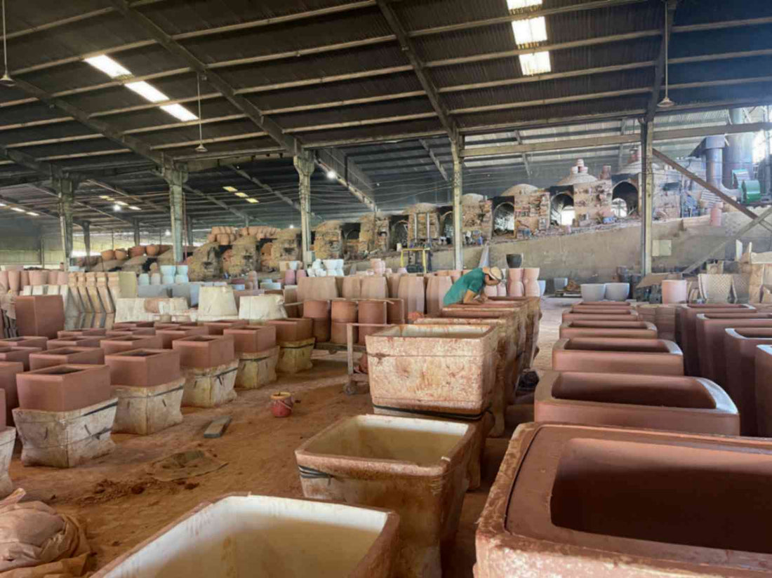 Image of pottery waiting for firing next to a dragon kiln at a factory