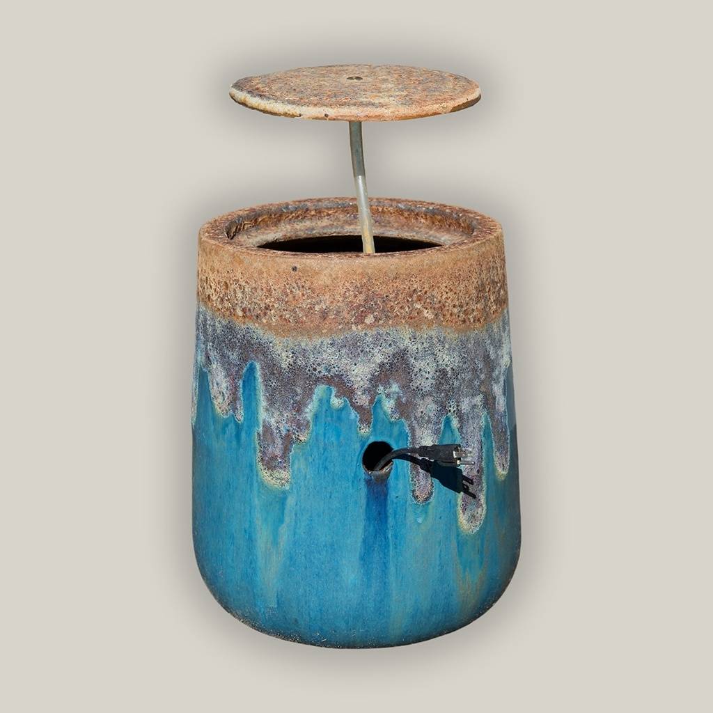 Glazed ceramic fountain jar in turquoise featuring a textured top and decorative dripping effect