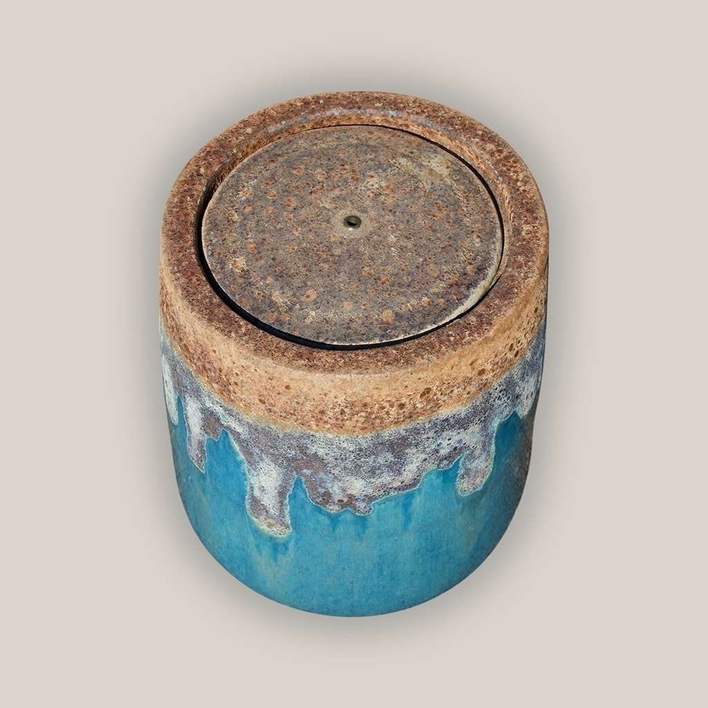 Glazed ceramic fountain jar in turquoise featuring a textured top and decorative dripping effect