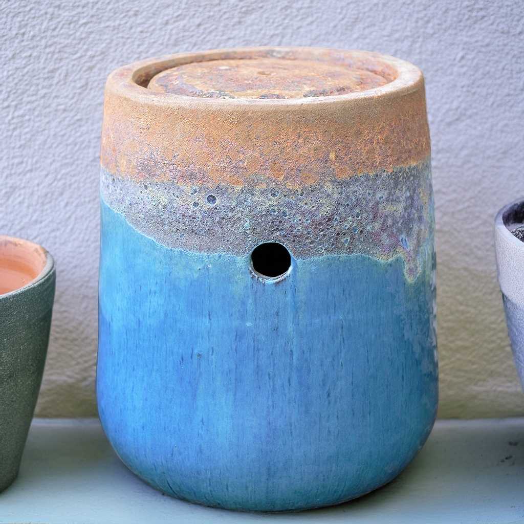 Glazed ceramic fountain jar in aqua blue with a rustic, unglazed top