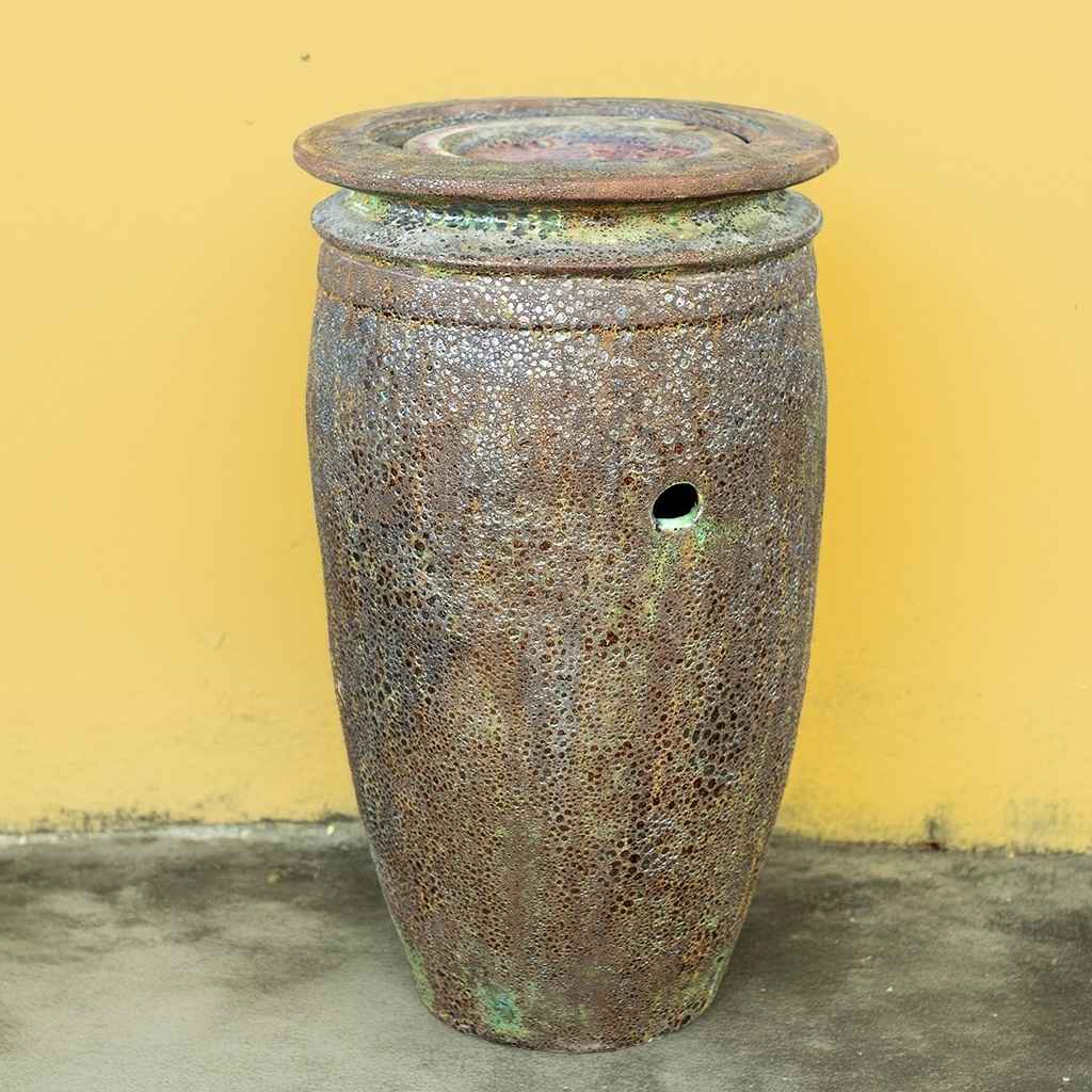 Majestic ceramic jar fountain with a textured, distressed finish in rich green and brown tones