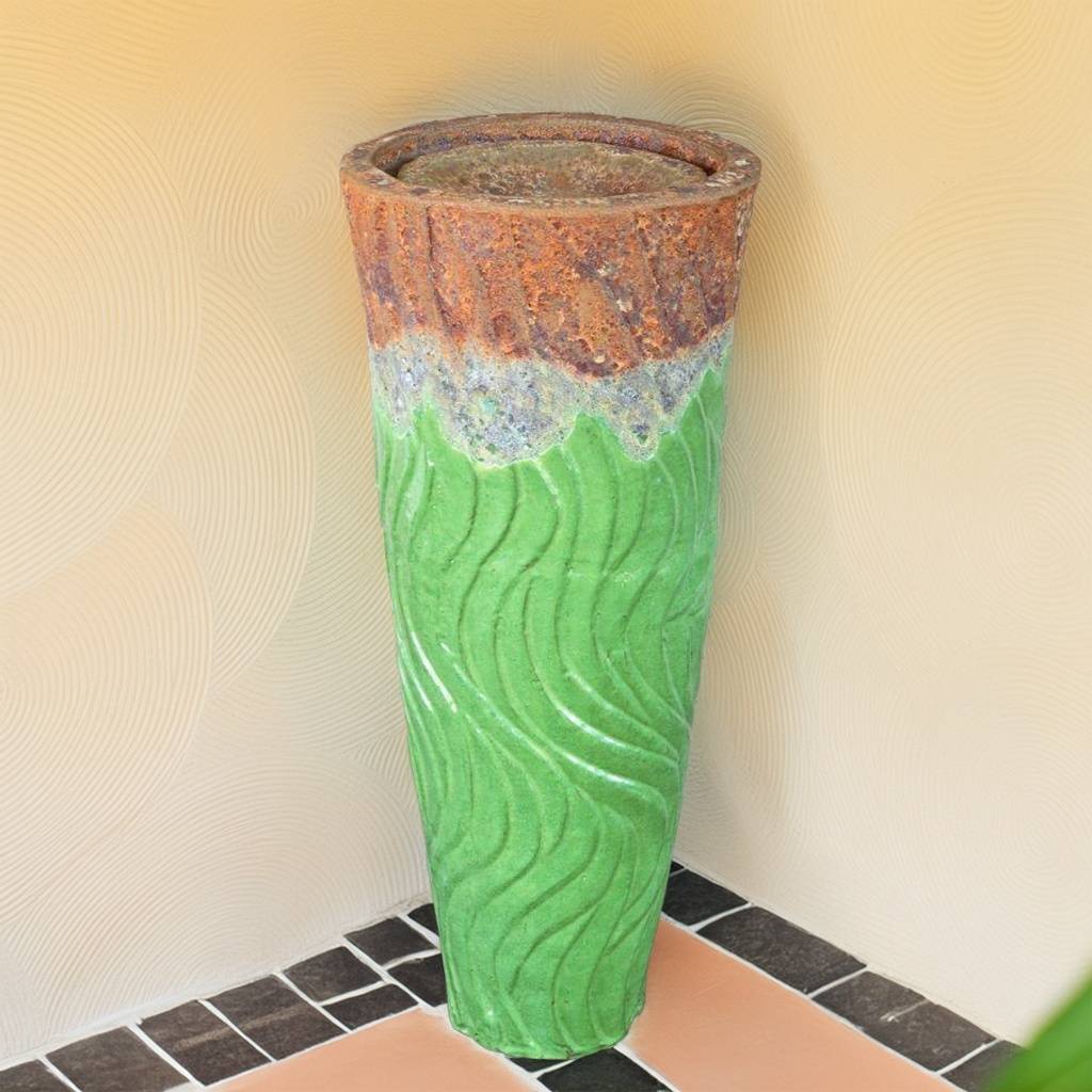 Swirled ceramic fountain jar glazed in apple green with a textured top