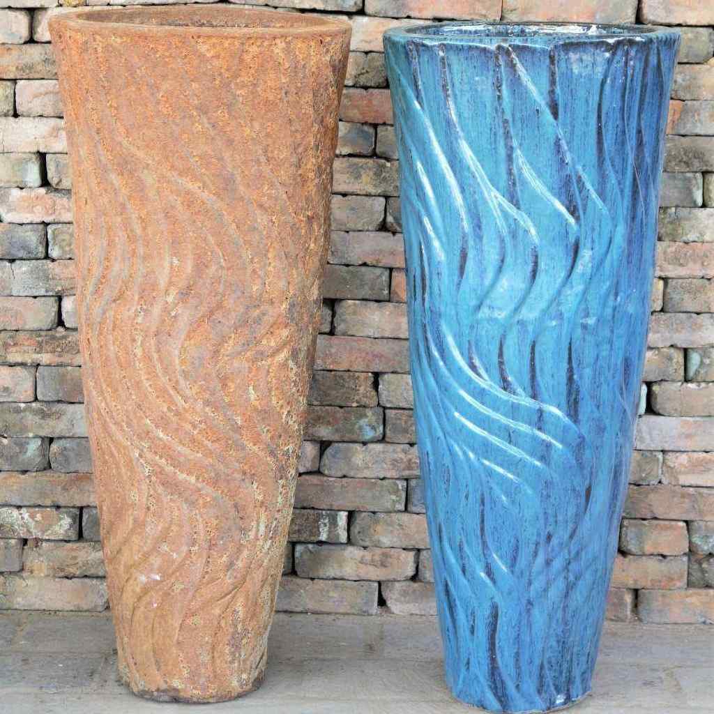 Two swirled ceramic fountain jars—one with a distressed brown and beige finish, the other in glossy blue