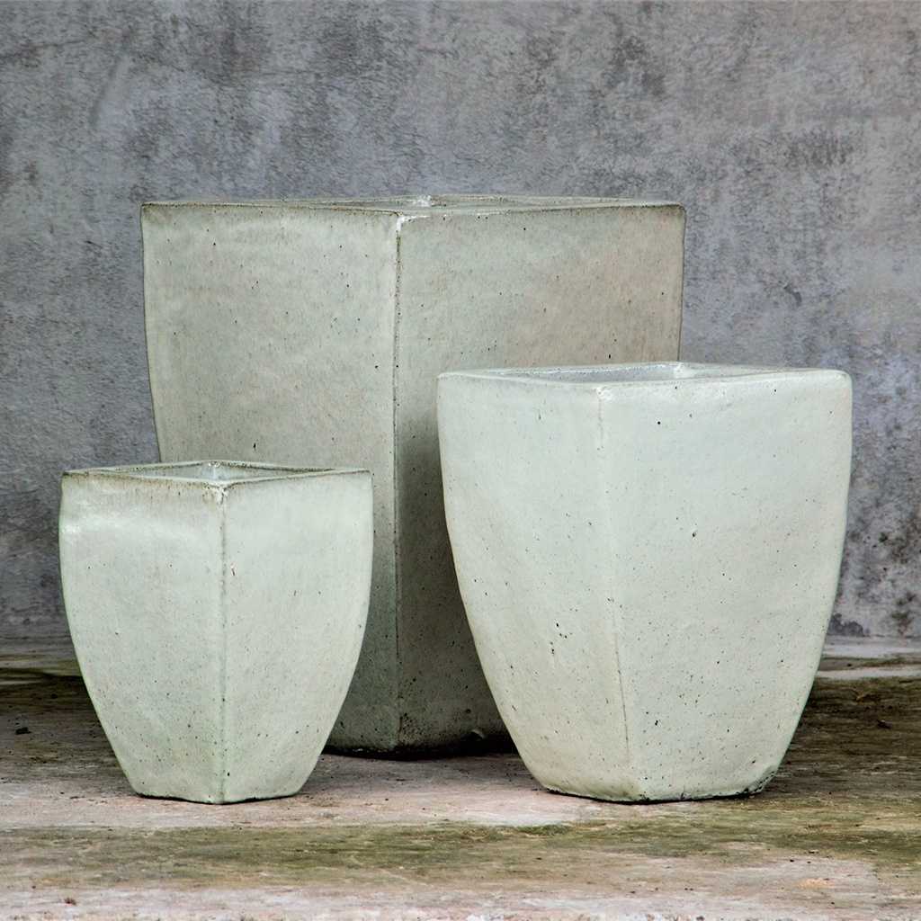 Tapered ceramic planters with a distressed white finish