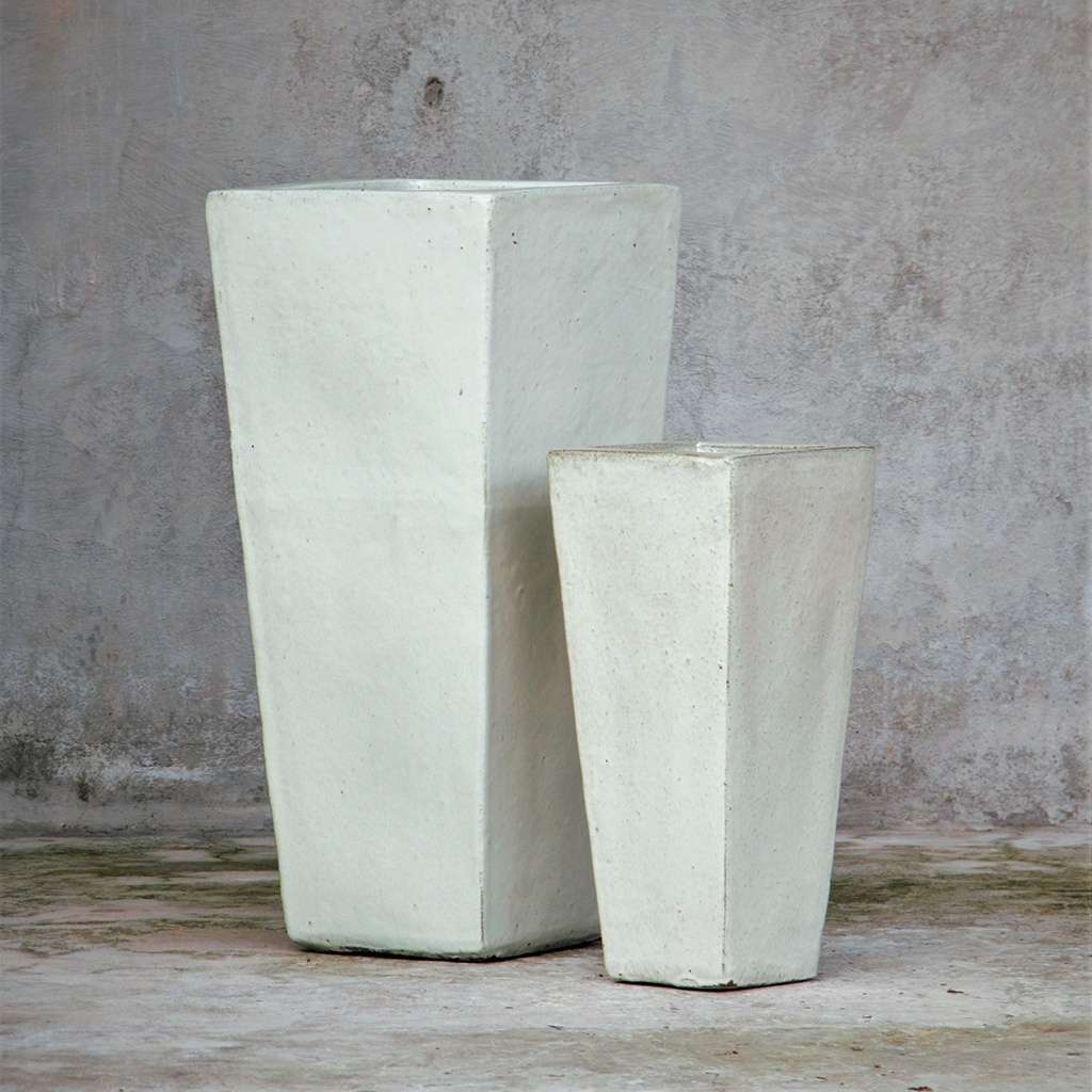 Matte white tapered planters in varying sizes for versatile, minimalist styling