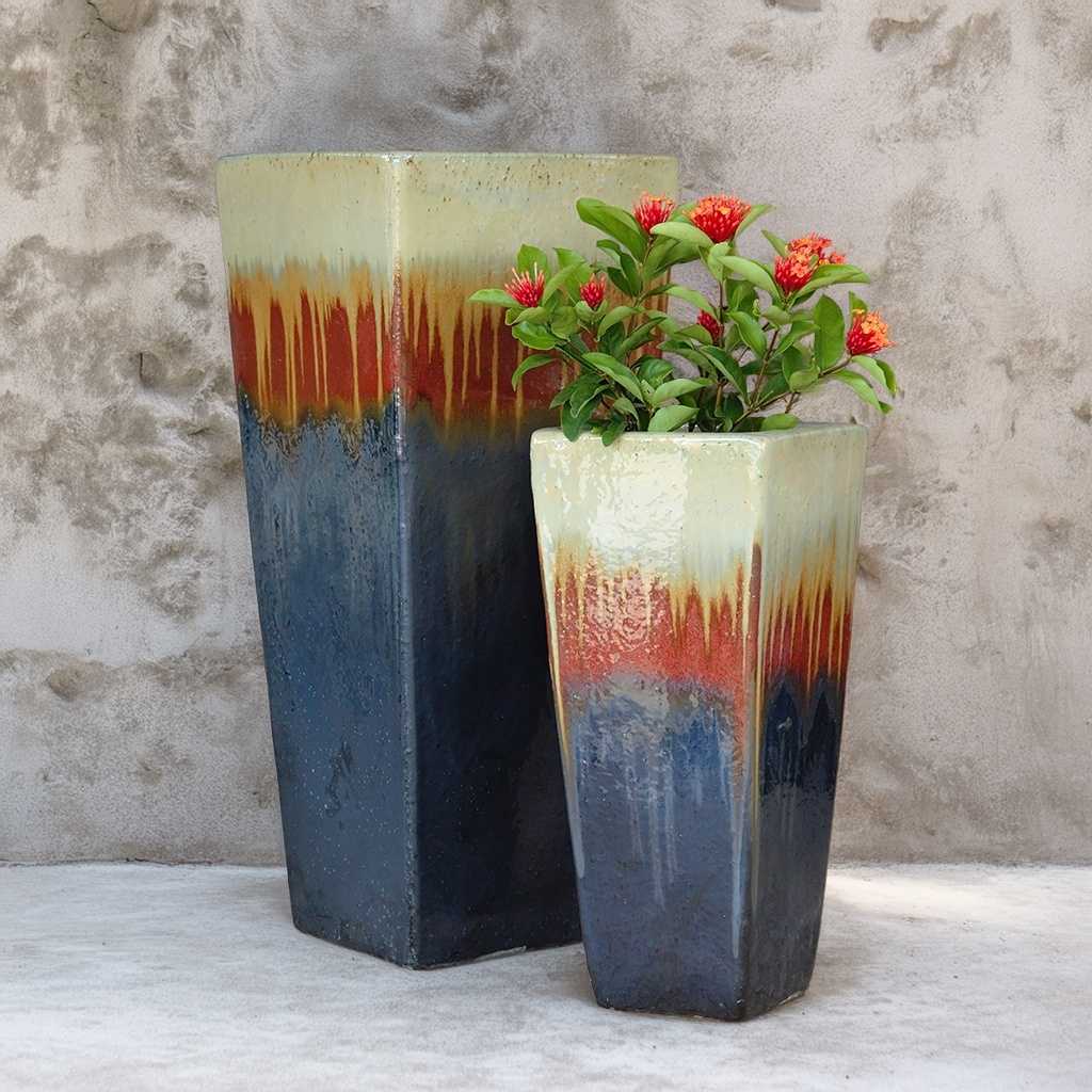 Ceramic tapered planters in shades of blue, orange, and cream for a warm and vibrant mix