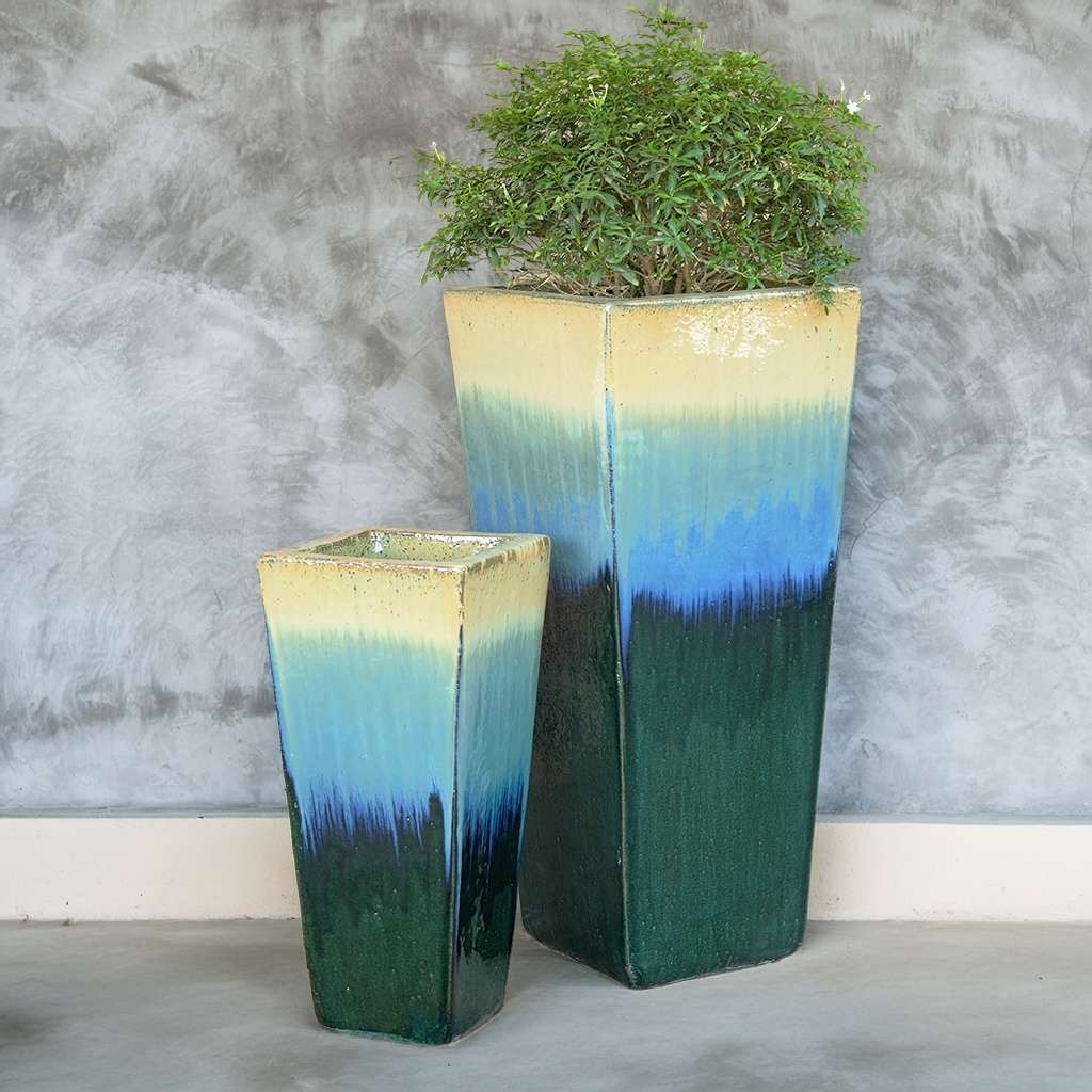 Ceramic tapered planters in a blend of dark green, light blue, and beige for a soft, earthy palette