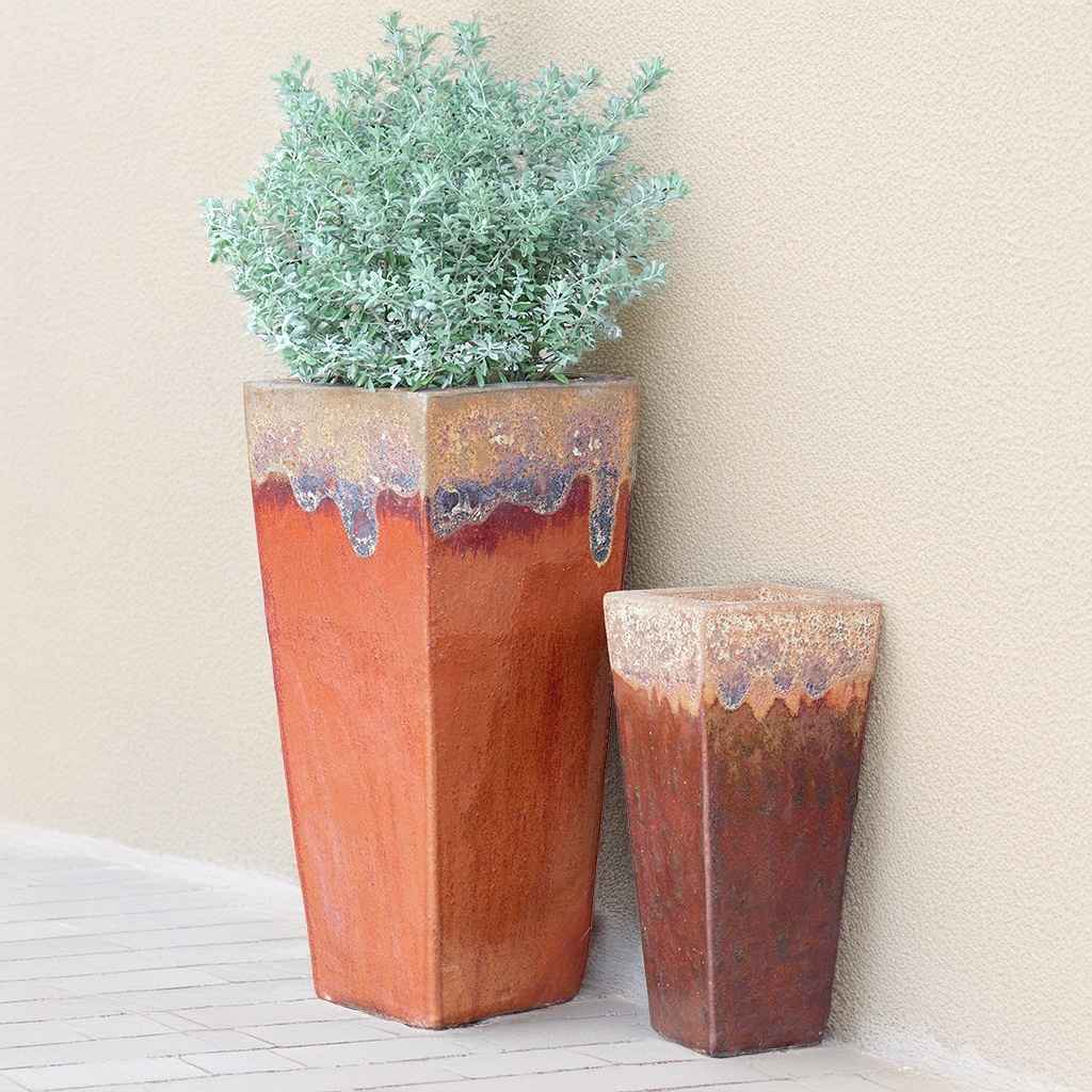 Tapered planters in terracotta orange-brown with a drip-effect top in cream, light blue-purple, and dark brown-rust tones for a rich, artistic finish