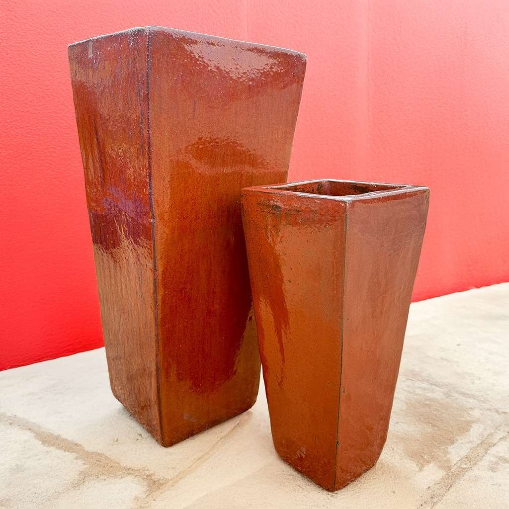 Glossy red tapered planters with a vibrant, polished finish