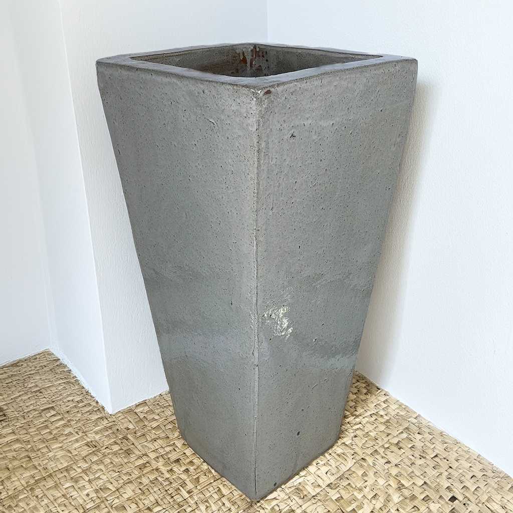 Light gray tapered planter with a smooth, modern look
