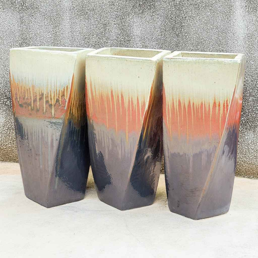 Modern twist planter in glazed dark grey, rust and cream