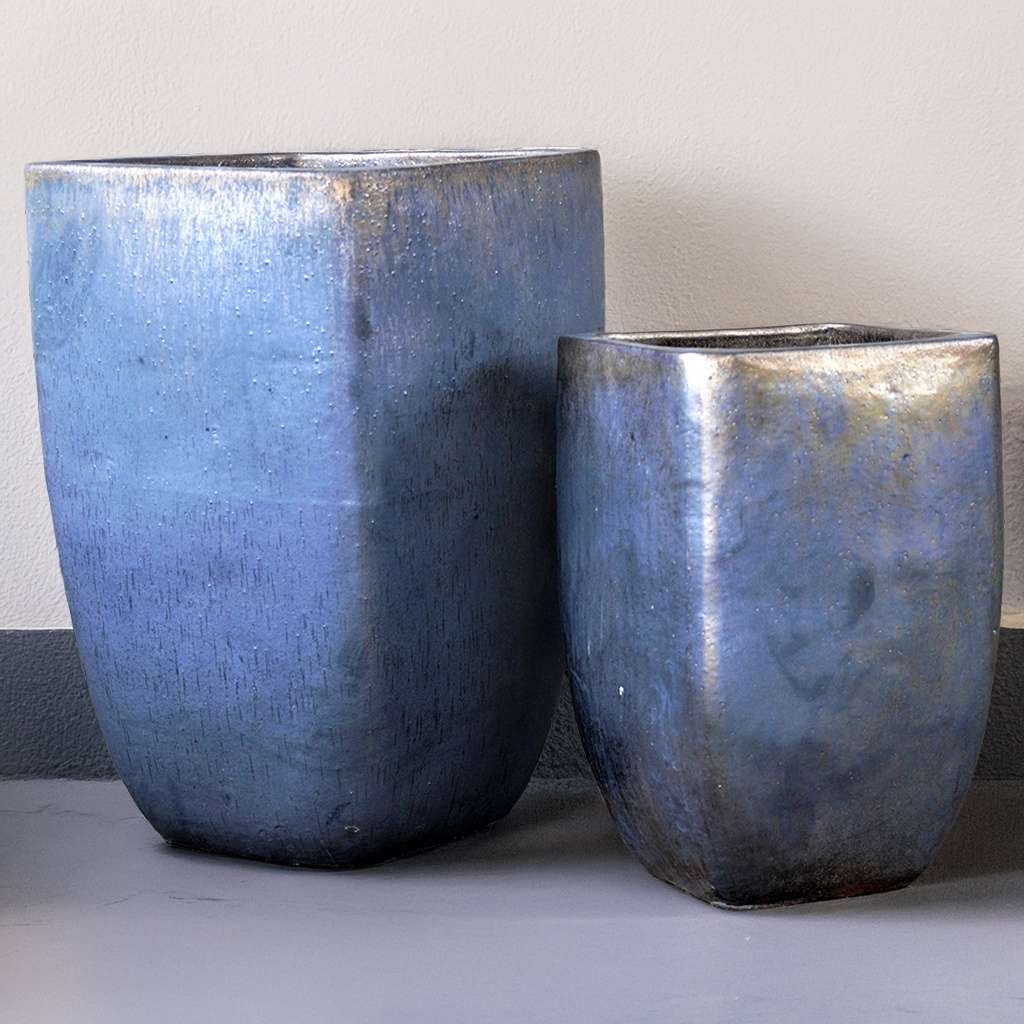 Tall square tapered planter in muted blue with metallic bronze-like accents for a modern, elegant touch