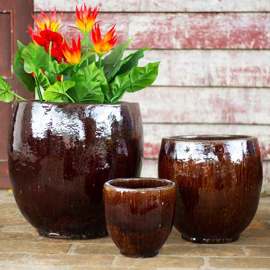Glossy brown round ceramic bulbous planters with a smooth, reflective finish and gently curved silhouette