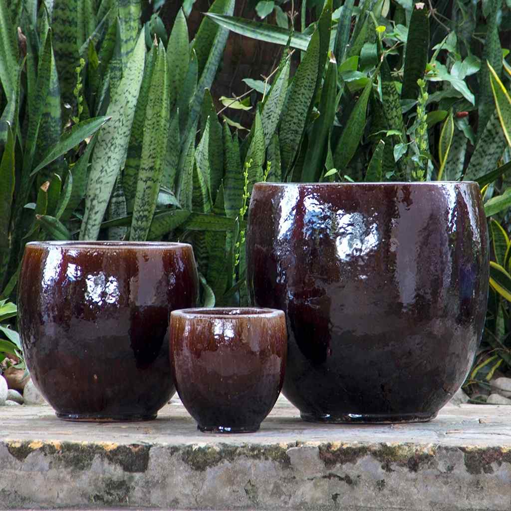 Dark brown round ceramic bulbous planters featuring a smooth, curved shape and rich, earthy glaze