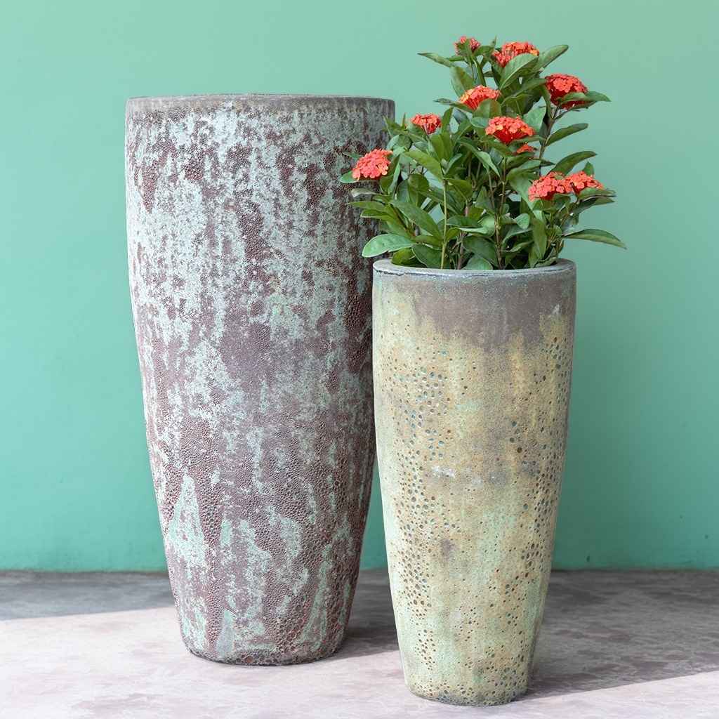 Tall tapered ceramic planters with a distressed, multi-layered glazed finish in rustic blue and green, featuring a textured, weathered appearance