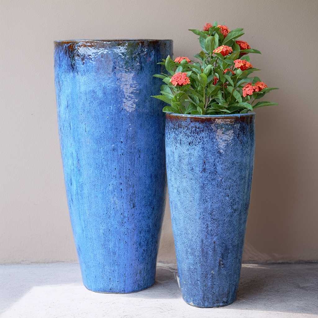 Glazed tall tapered ceramic planters in aqua blue with a contrasting brown rim