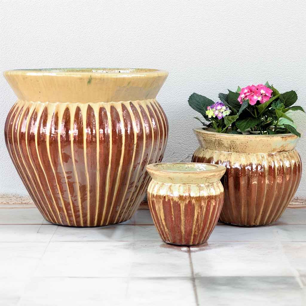 Two-toned wide round ceramic planter featuring vertical fluting in creamy beige and a rich reddish-brown base for added depth and texture