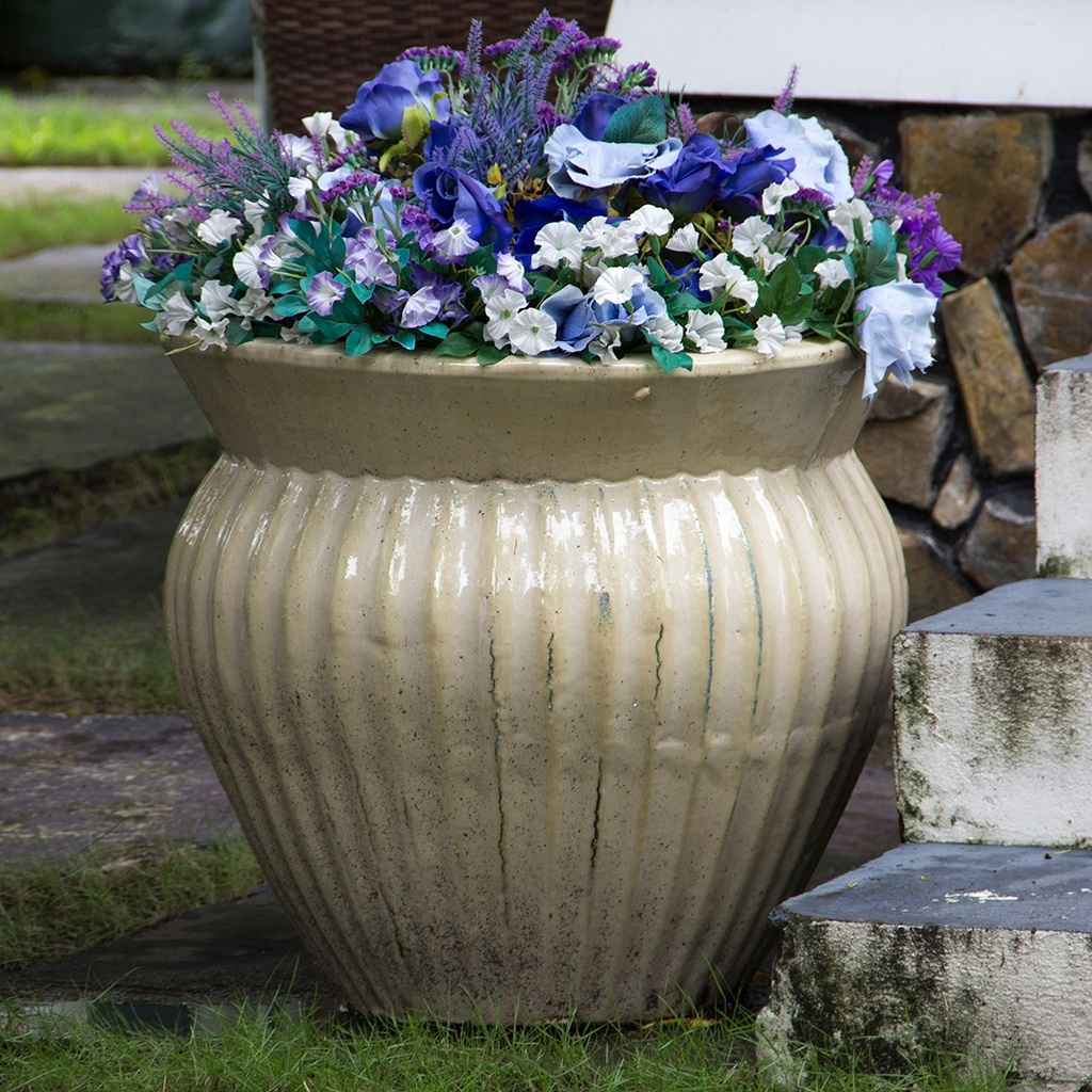 Wide round ceramic planter in glossy cream finish, featuring elegant vertical fluting for added texture and style