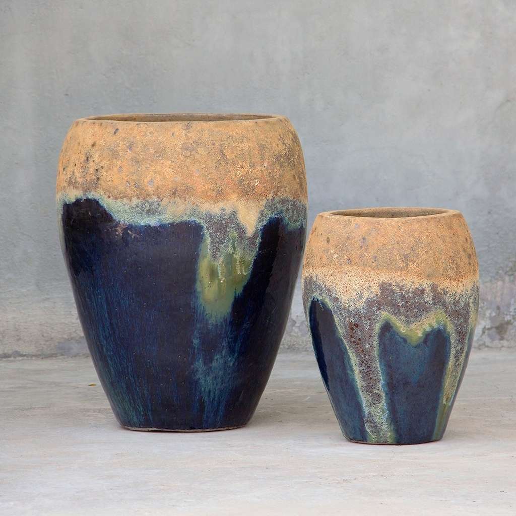 Egg-shaped planter with a dark blue glaze and a sandy brown rim