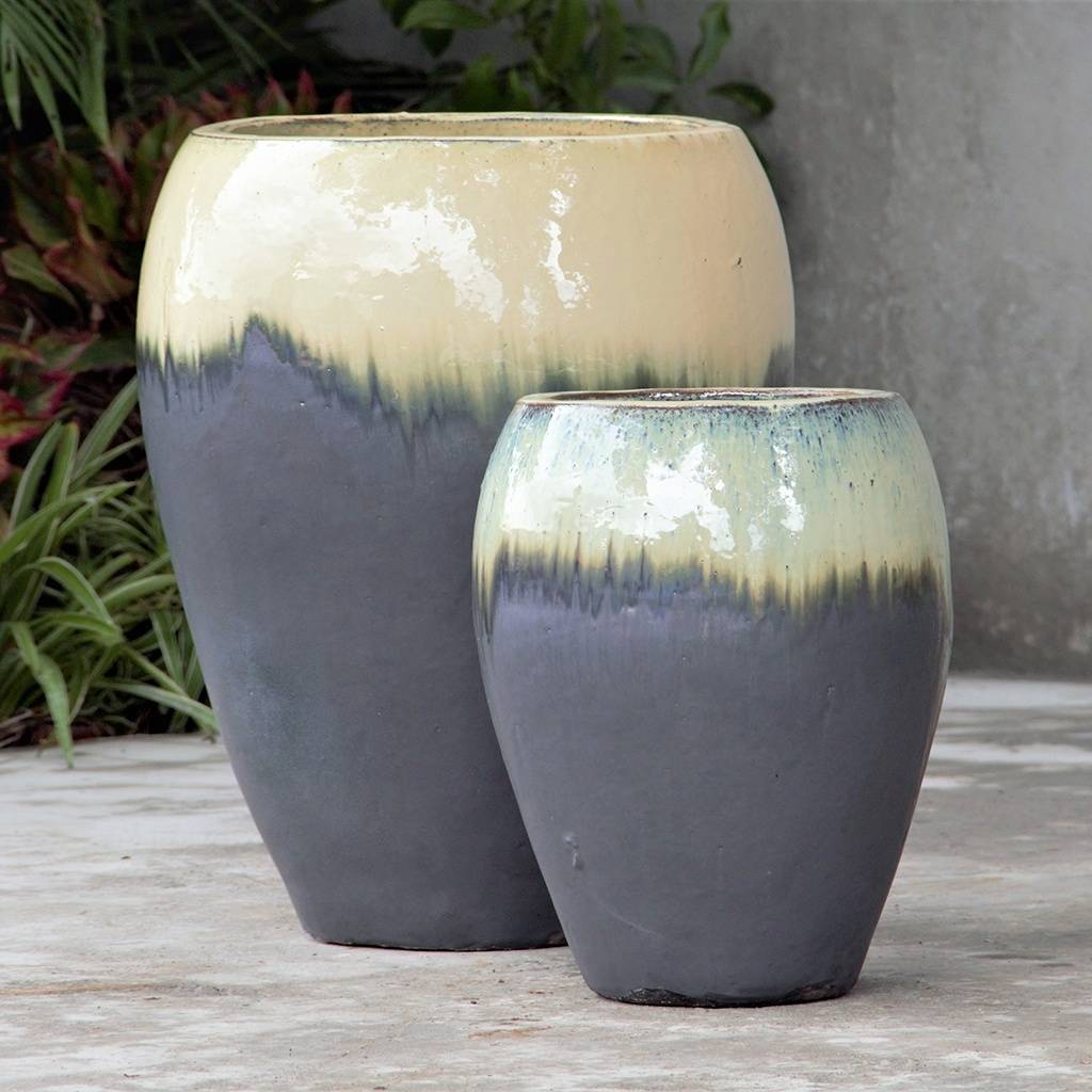 egg-shaped planter pot with smooth curves in gray and cream finish