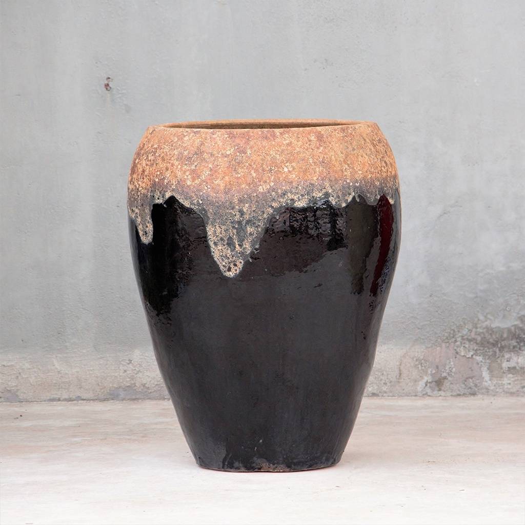 Egg-shaped planter in black brown with distressed dripping effect