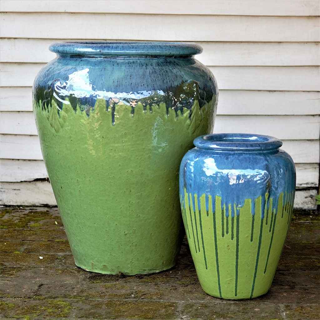 Tall, rounded jar-style planters in apple green featuring a turquoise rim and a distinctive dripping glaze effect