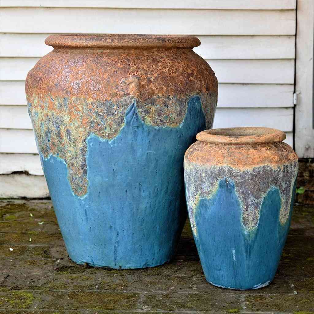 Tall, rounded jar-style planters in blue featuring a textured rim and a distinctive dripping glaze effect