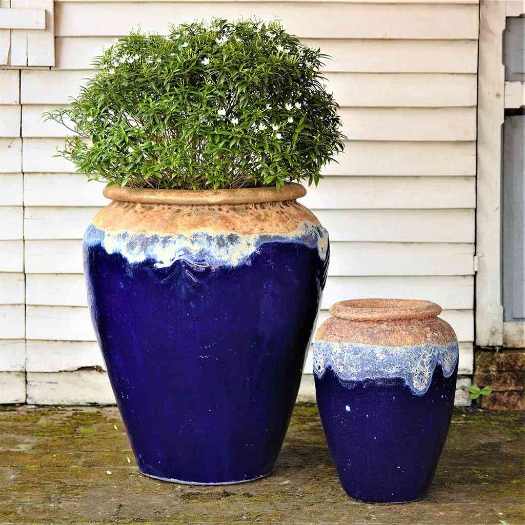 Tall, rounded jar-style planters in dark blue featuring a textured rim and a distinctive dripping glaze effect
