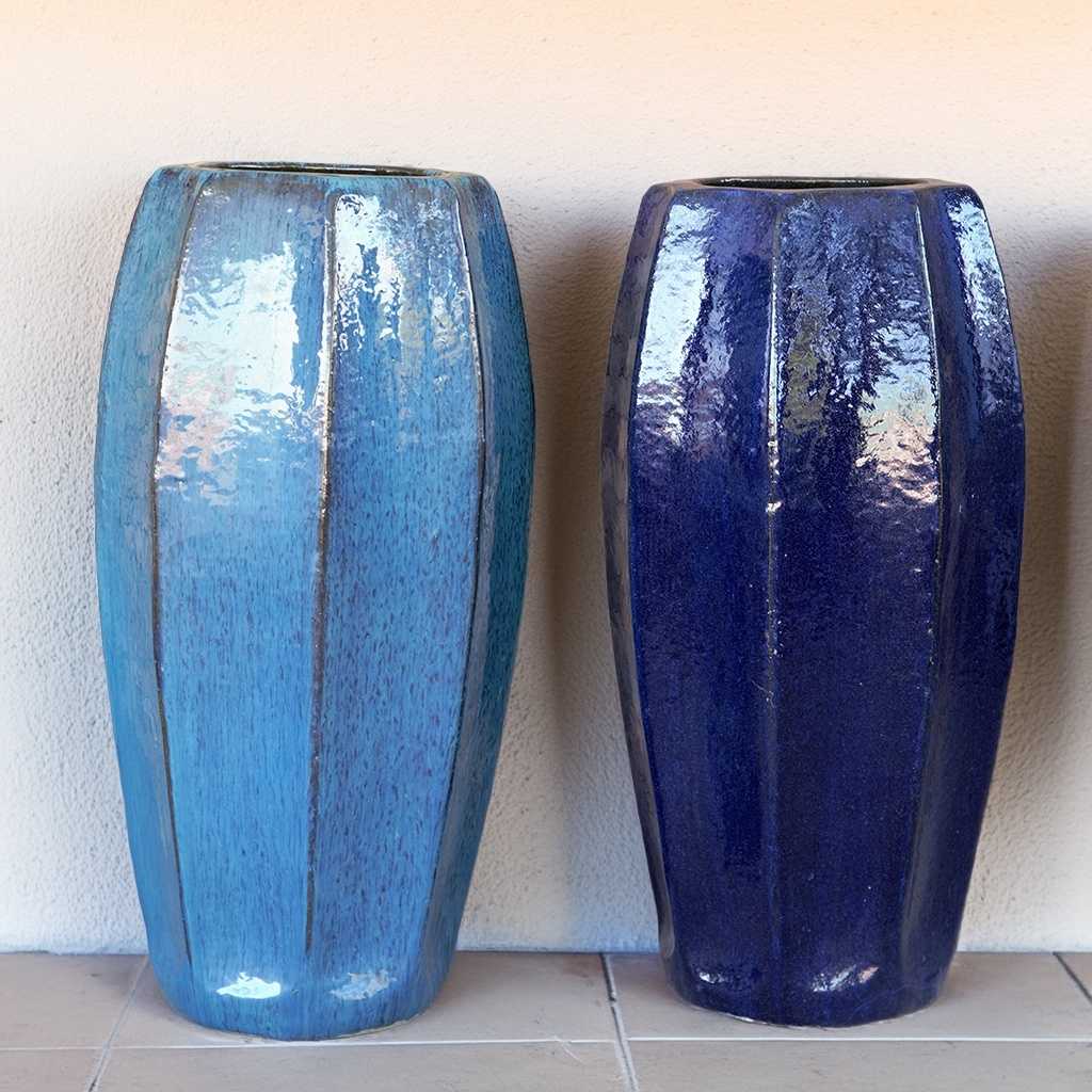 Two tall faceted ceramic planters, one in aqua blue and the other in deep blue