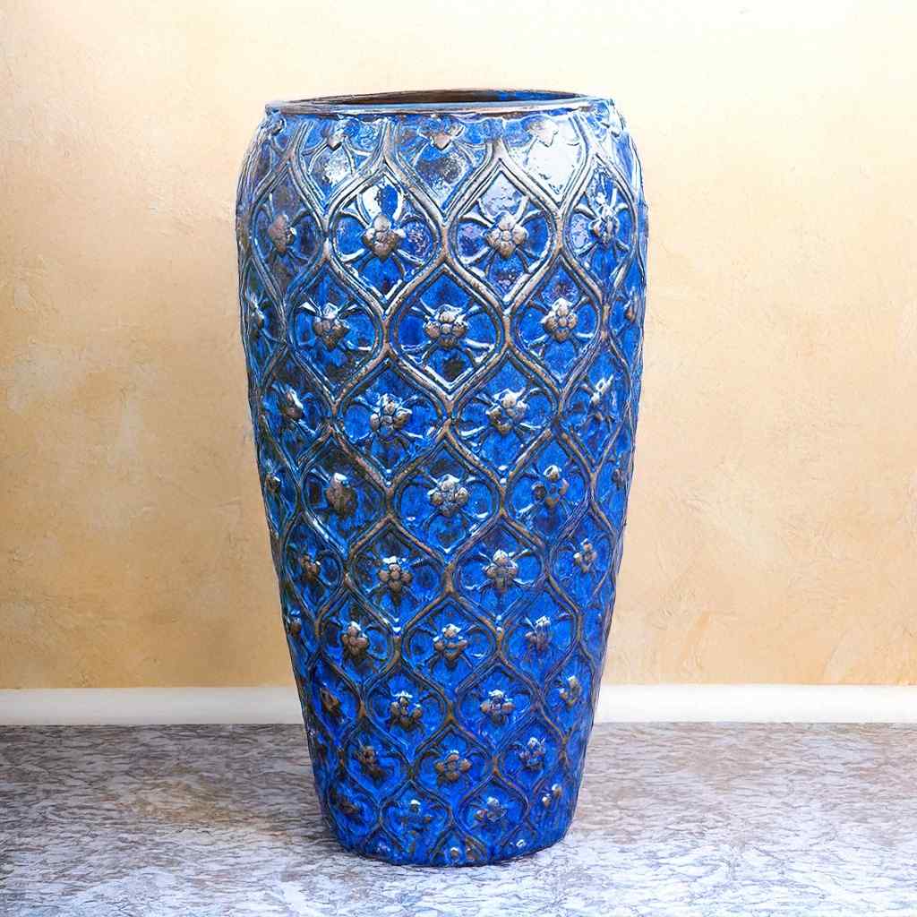 Ornamental ceramic planter glazed in vibrant blue