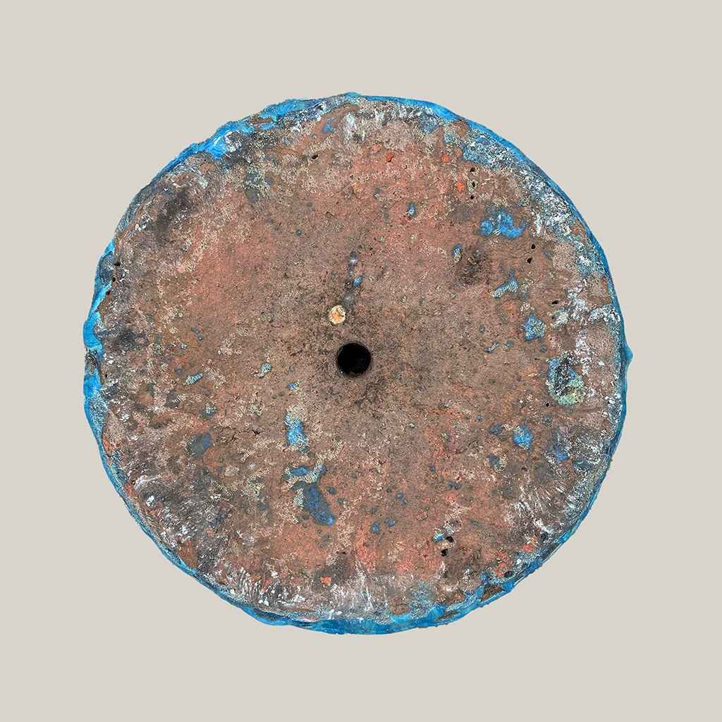 Bottom view of tall ridged ceramic planter in blue with brown accents