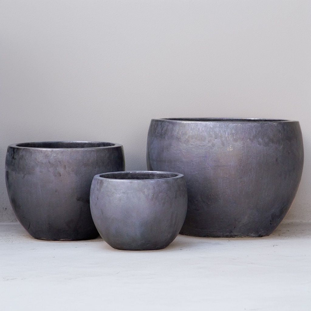 Ceramic rounded planters with a smooth matte black finish