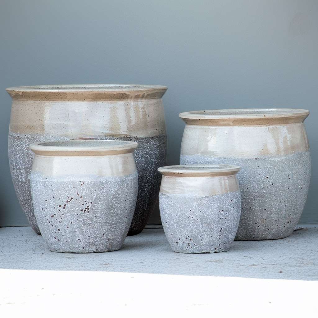 Rounded ceramic planter featuring a textured gray body with a glossy cream-colored top