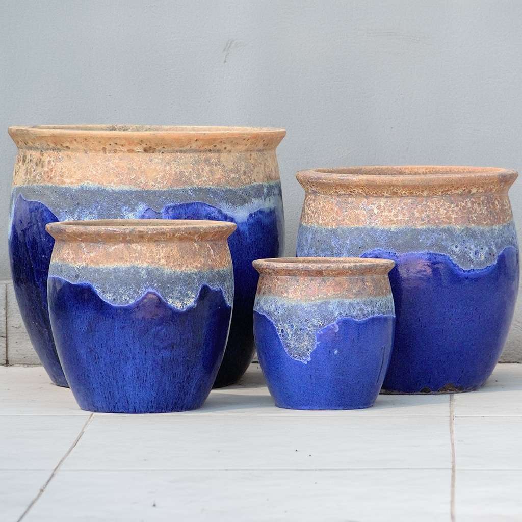 Rustic rounded ceramic planter in dark blue with a textured, weathered top for a natural, handcrafted feel