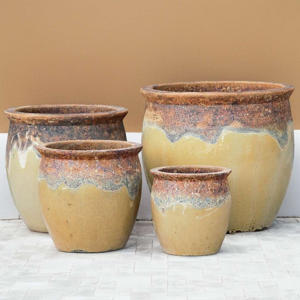 Rustic rounded ceramic planter in beige featuring a textured, natural-finish top