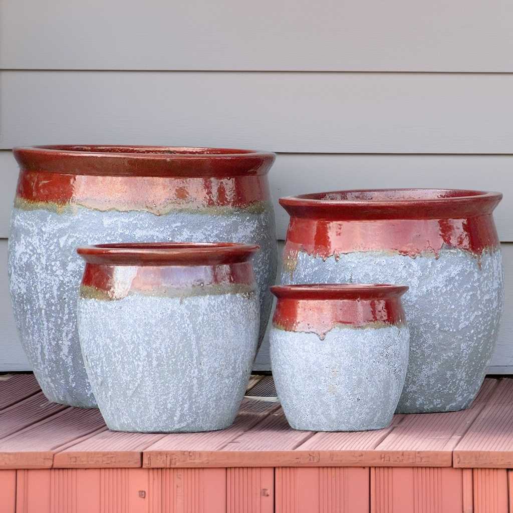 Rounded ceramic planter with a textured gray body and a glossy red-brown top