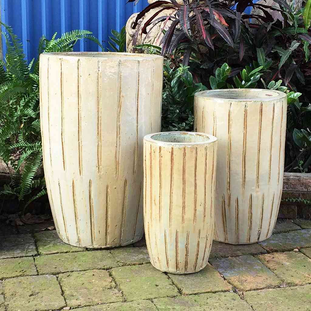 Tall planter in beige with a vertical line texture for a sleek, modern design