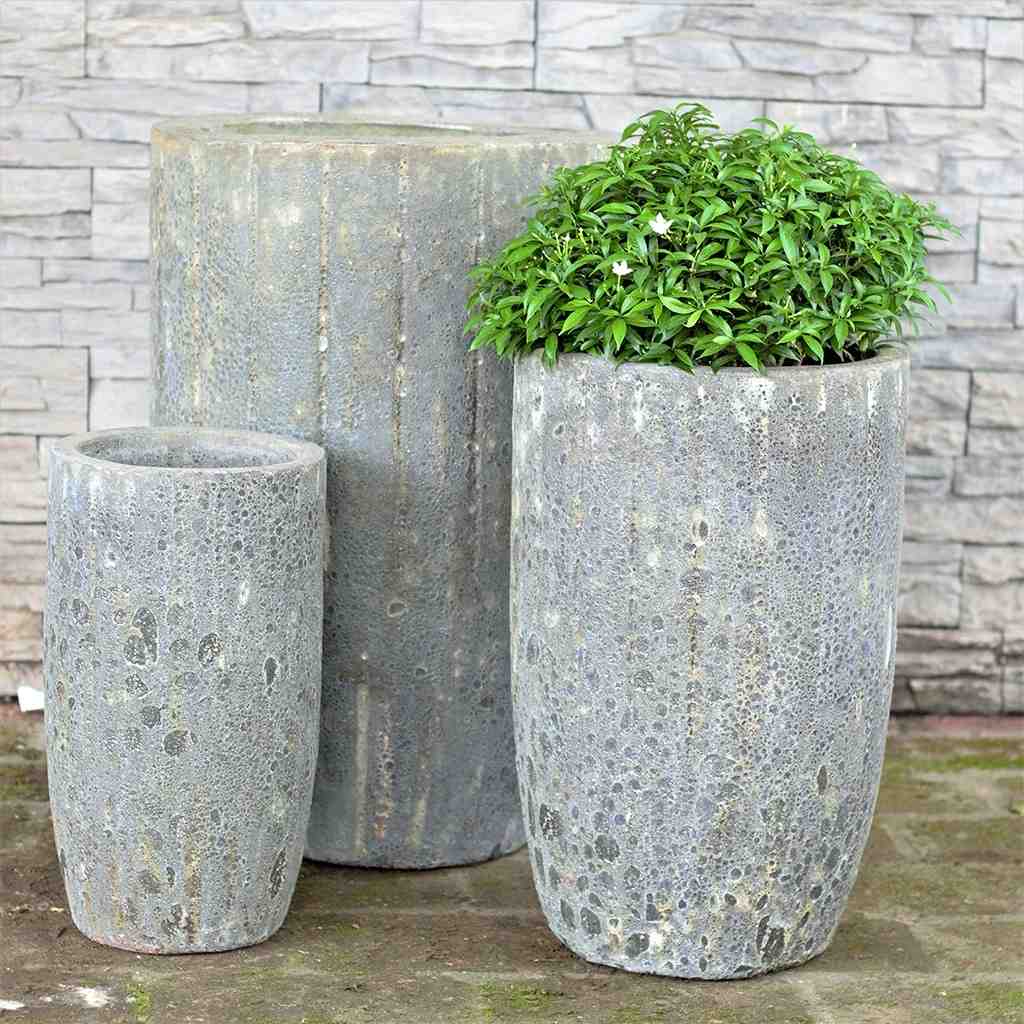 Tall planter in stone grey with vertical lines and a textured finish