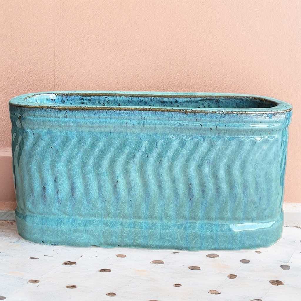 Rectangular planter with a wavy embossed pattern in a rich teal color