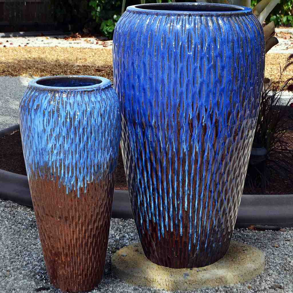 Tall floor vase with dimpled texture in vibrant blue, accented by rustic brown highlights