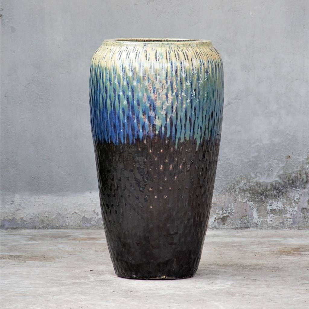 Tall floor vase with a dimpled texture, glazed in cream, blue, and dark brown for a vibrant, multi-colored finish