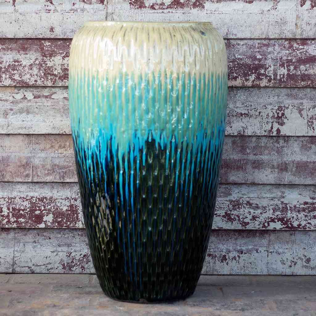 Tall floor vase with a dimpled texture, featuring a glazed finish in cream, teal, aqua blue, and dark green for a vibrant, multi-colored look