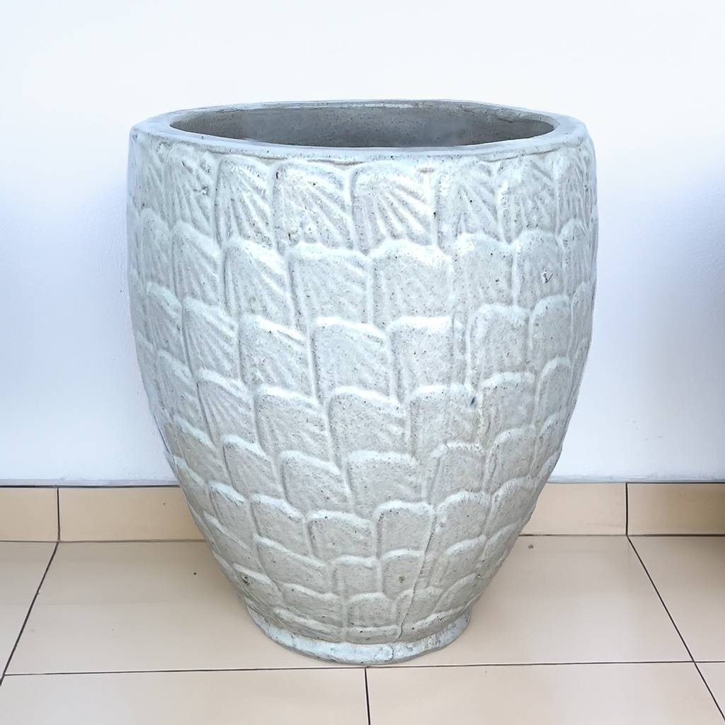 White ceramic garden pot with a textured scallop pattern