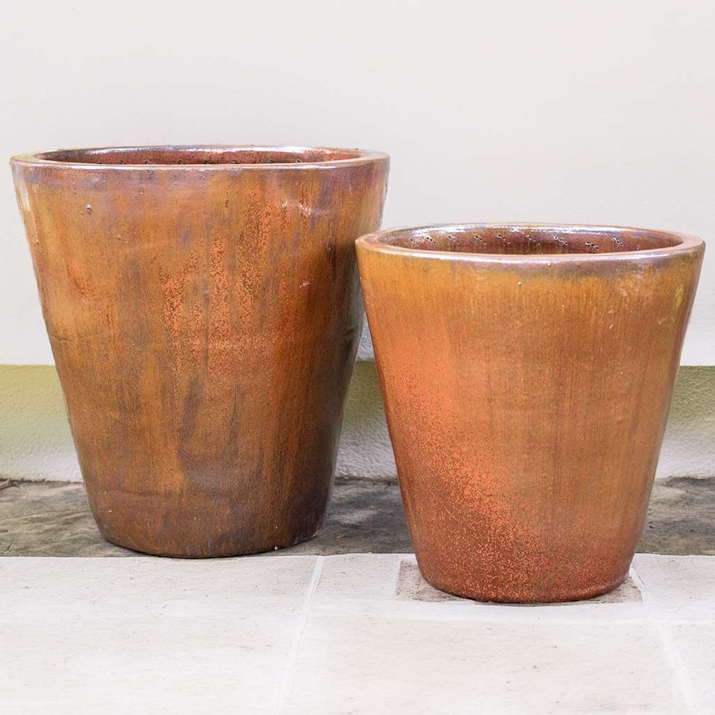 Tapered cylinder planter pots with wide mouth, featuring a rustic orange finish and a smooth, minimalist design