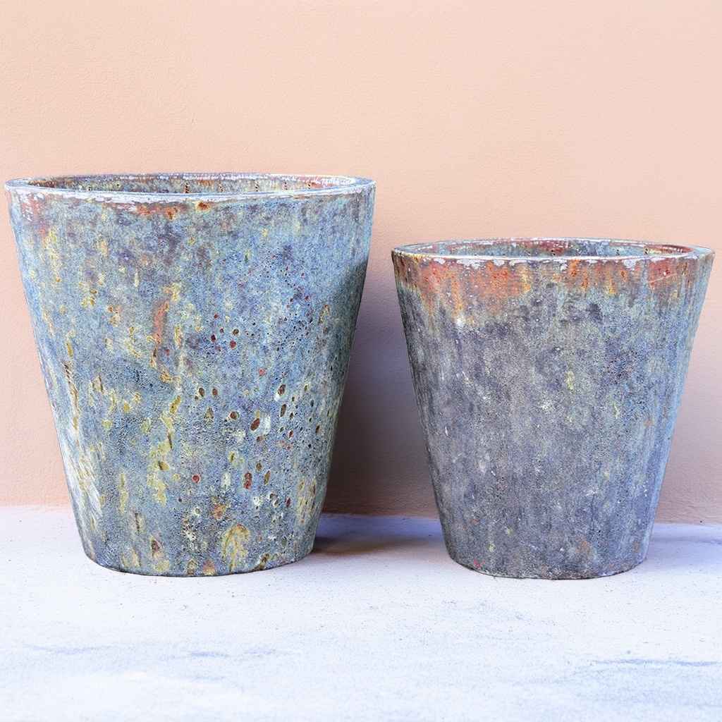Tapered cylinder planter pots with wide mouths, featuring muted grey and blue tones and a weathered stone texture for a natural, rustic design
