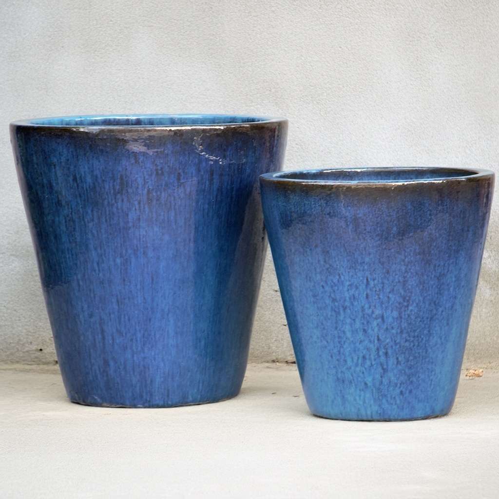 Tapered cylinder planter pots in glazed blue with a wide mouth, featuring a smooth finish and modern silhouette