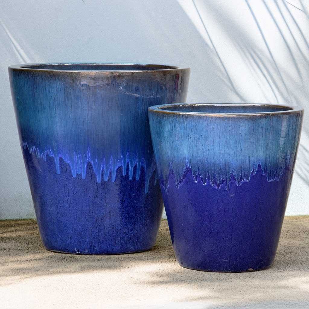 Tapered cylinder planter pots in blue featuring a dripping glaze design for a bold, artistic finish