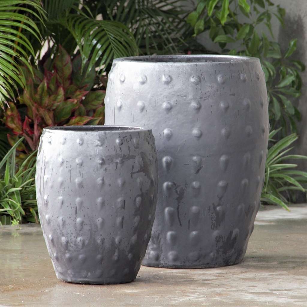 Barrel-shaped planters in light gray featuring a raised dot texture