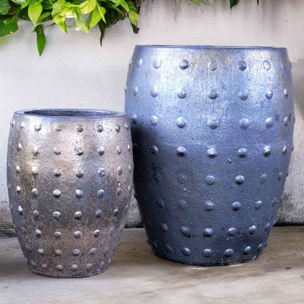 Barrel-shaped planters in metallic gray featuring a raised dot texture